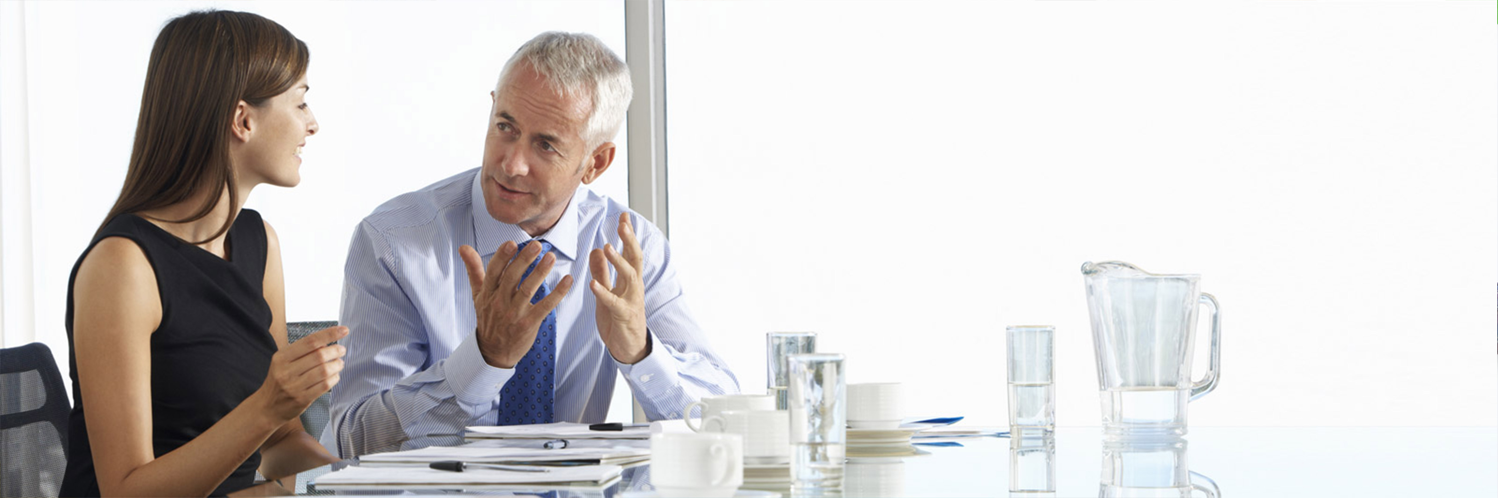 a male assessor having a discussion with a female apprentice