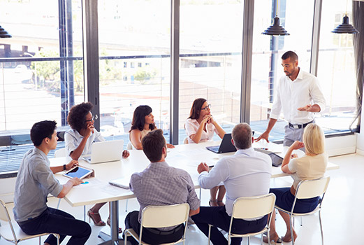 a manager with his team around a table