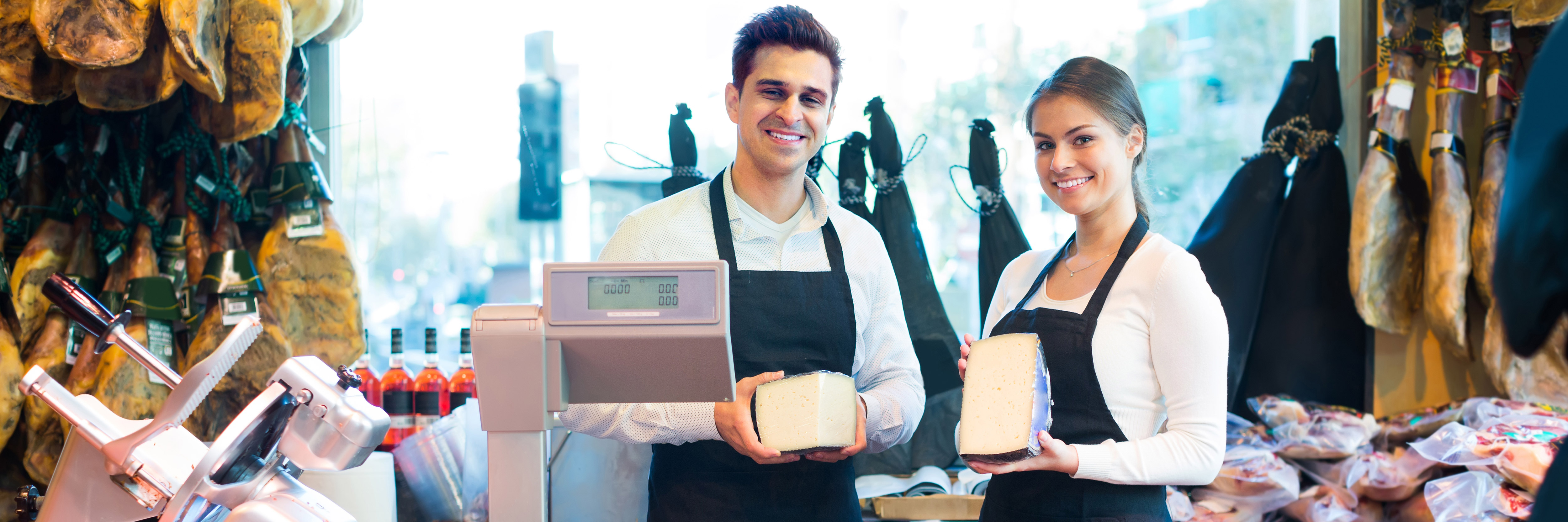 a Retail Team Leader and assistant stood behind a cheese counter